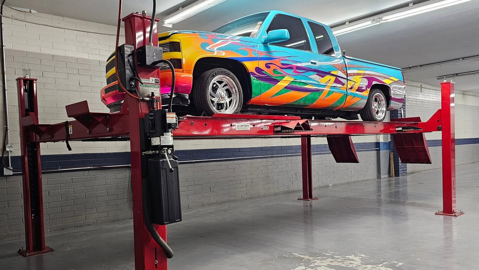 Custom flame-painted OBS Chevy truck on the Hunter alignment rack at Automotive Dynamics in Sun City, Arizona