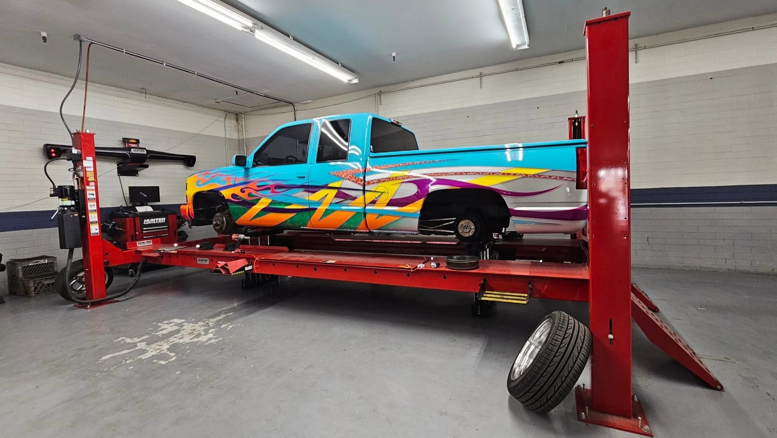 Lowered custom Chevy truck getting an alignment on the Hunter rack at Automotive Dynamics in Sun City, Arizona